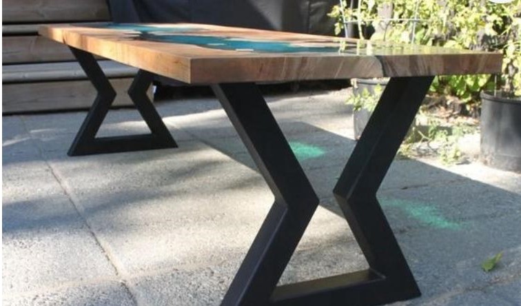 Mesa rústica com tampo de madeira maciça e detalhe em resina epóxi azul, base metálica em X
